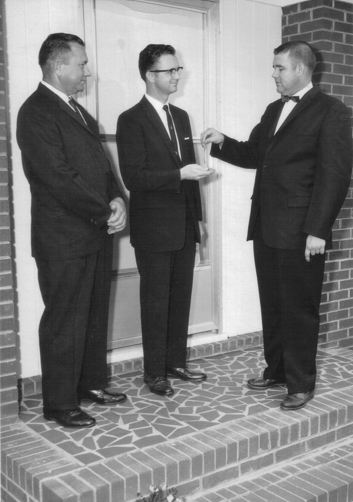 1962 – Note Burning 1 December 22, 1962 — Pastor Julian Motley, Rex Bradley, and Clinton Abernathy at Rawls Baptist Church in Fuquay-Varina, NC, during the burning of the parsonage mortgage note.