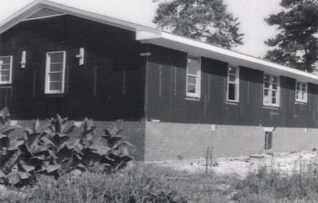 North Side Framing and Brickwork Construction of the Rawls Baptist Church parsonage in Fuquay-Varina, NC, during July 1960, showing progress and congregation involvement.