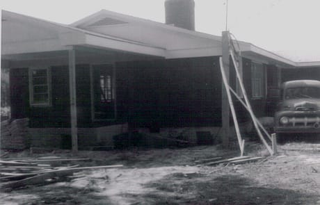Front Porch and Roof Framing Progress Construction of the Rawls Baptist Church parsonage in Fuquay-Varina, NC, during July 1960, showing progress and congregation involvement.