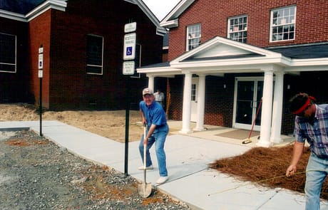 Laying Sidewalks and Parking Signs, 2005 Rawls Baptist Church volunteer helping prepare the front walkway and landscaping during completion of the 2005 church addition.