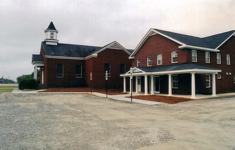 Completed Addition, 2005 Finished exterior of Rawls Baptist Church addition in Fuquay-Varina, NC, showing completed brick structure and new landscaping.