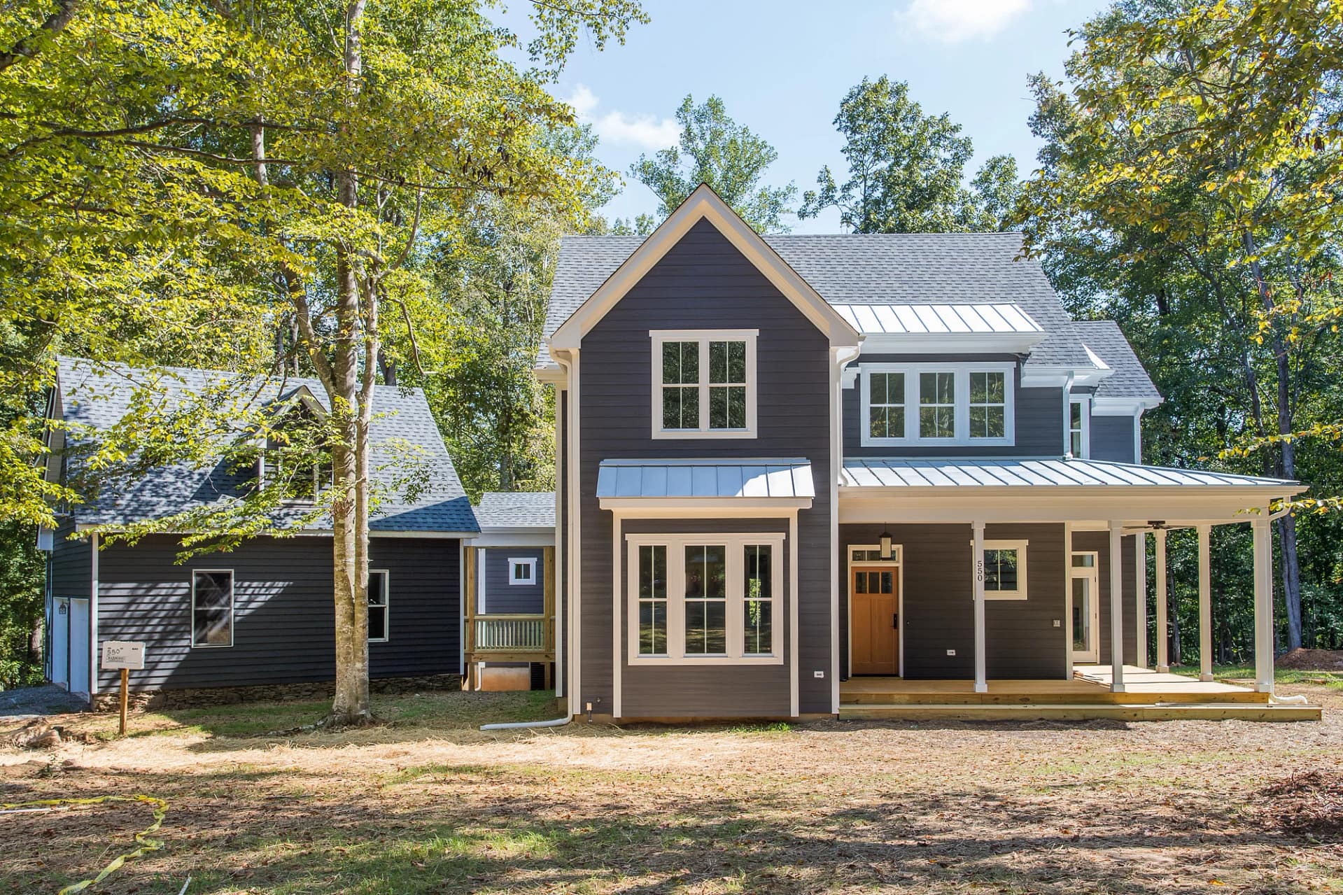 Front exterior of Pittsboro custom home with metal roof and covered porch