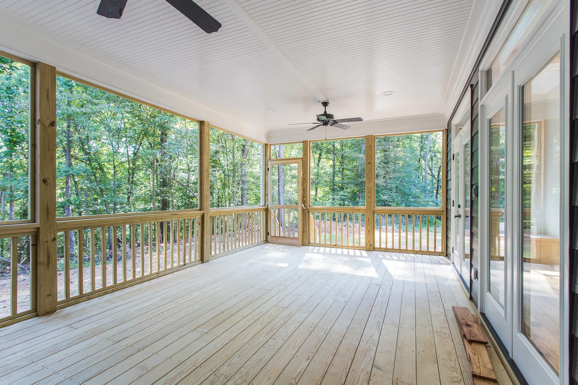 Screened porch with wood decking and forest views in Pittsboro custom home