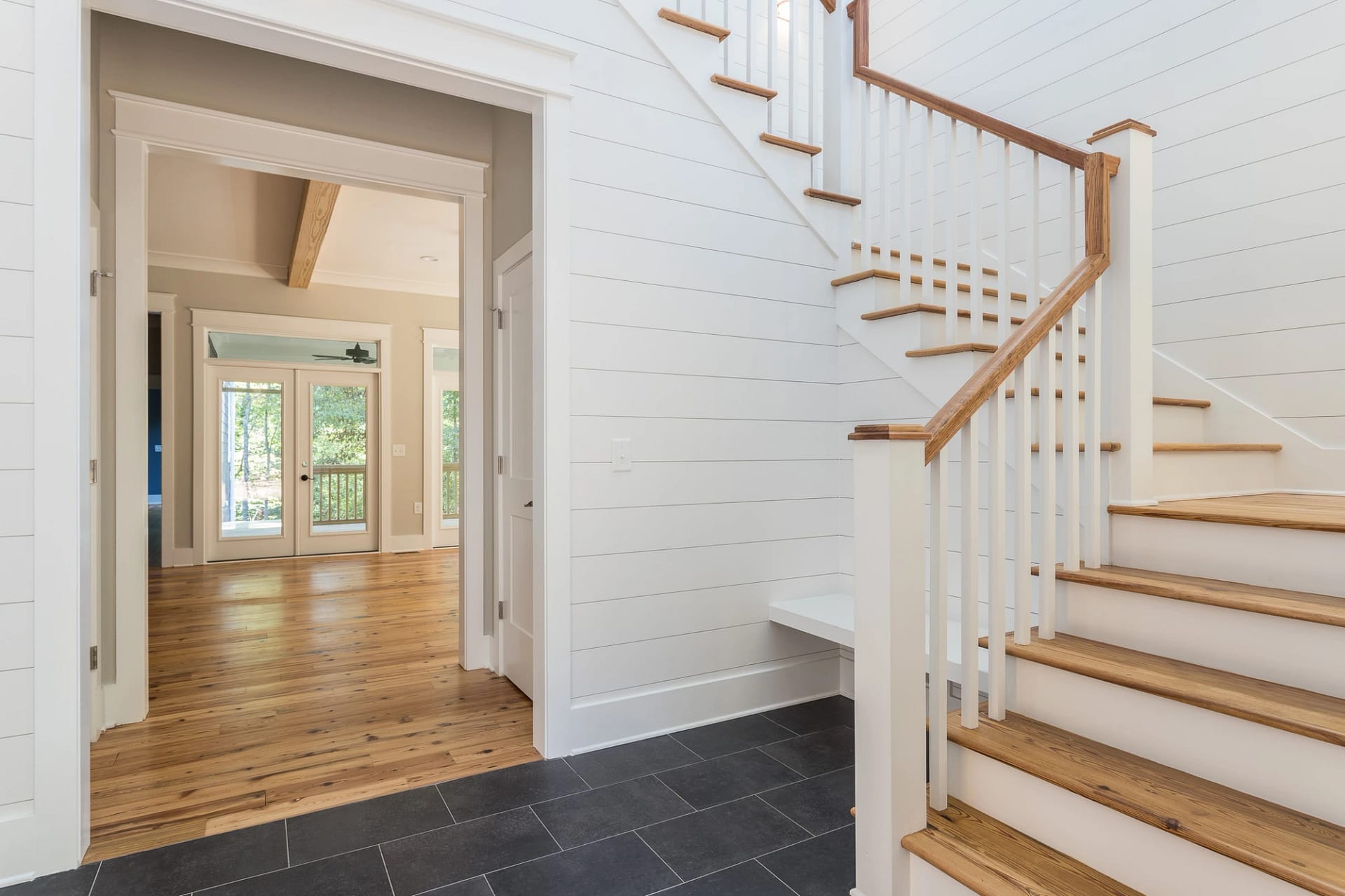 Entryway with staircase and shiplap walls in Pittsboro custom home