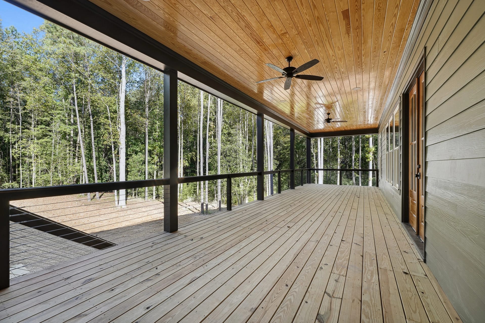 Screened outdoor living porch of a custom-built home in Holly Springs, North Carolina