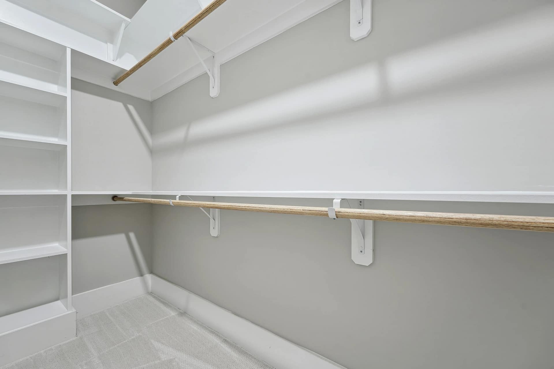 Walk-in closet with built-in shelving in a custom home in Holly Springs, North Carolina