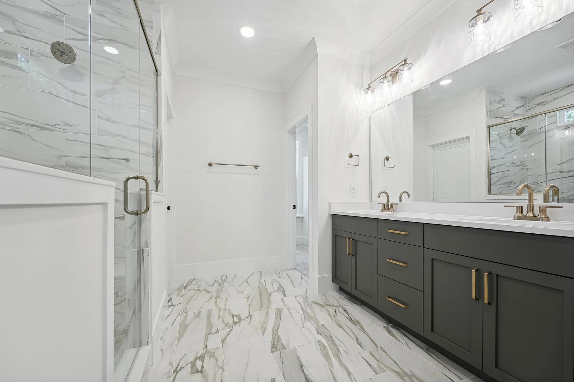 Primary bathroom with tiled shower in a new construction home in Holly Springs, North Carolina