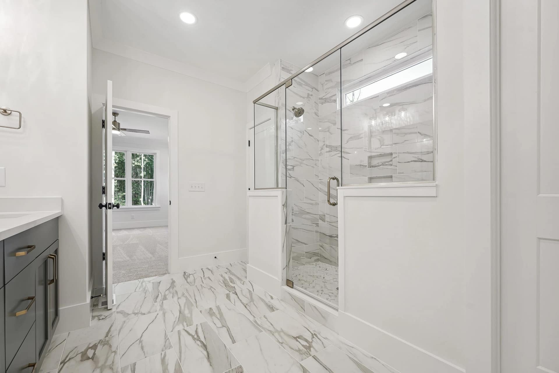 Secondary bathroom with walk-in shower in a new construction home in Holly Springs, North Carolina