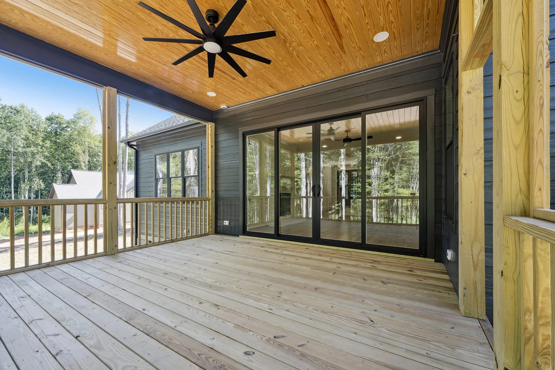 Screened porch with wood ceiling in a new construction home in Holly Springs, North Carolina