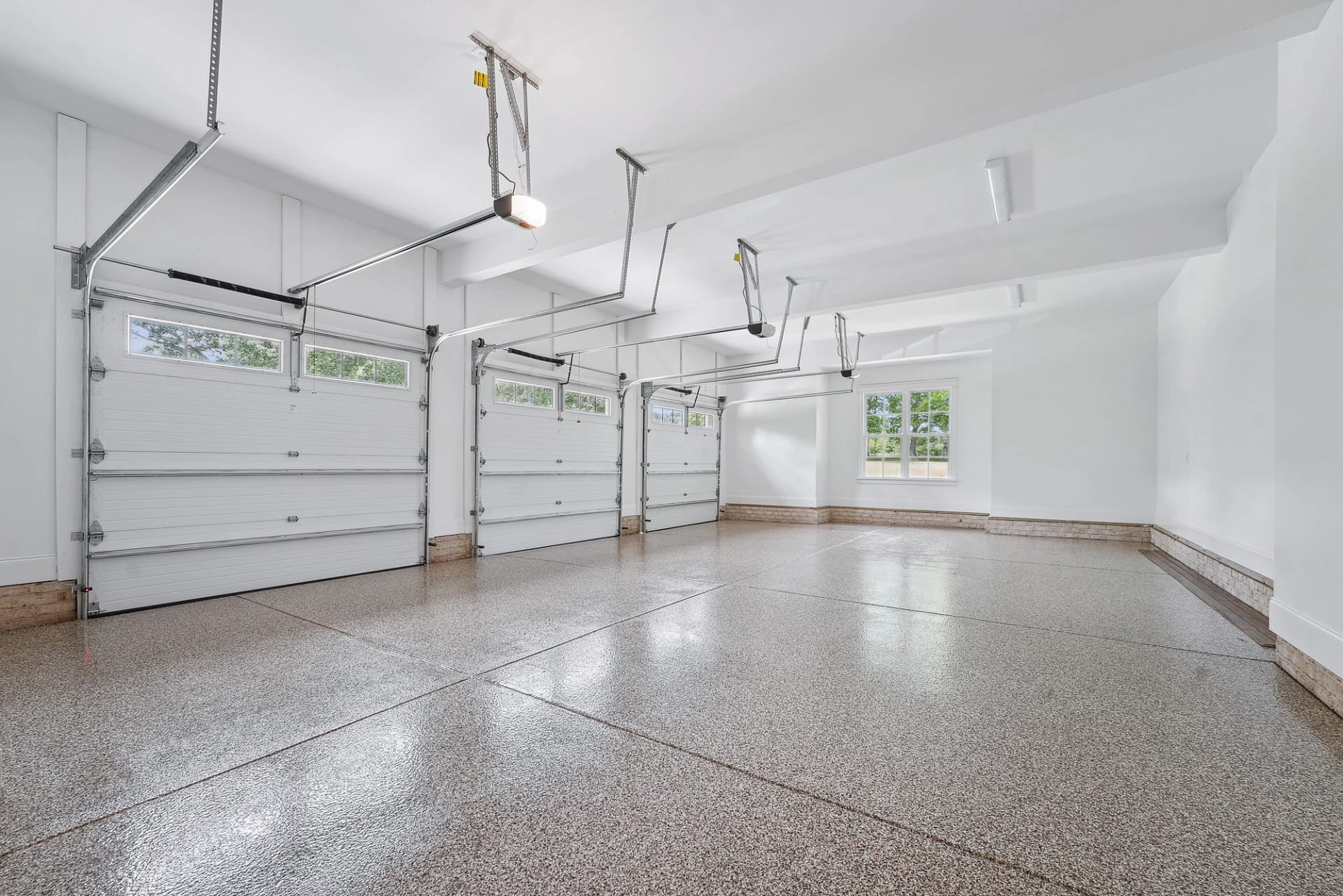 Oversized garage interior with finished floors in Holly Springs home
