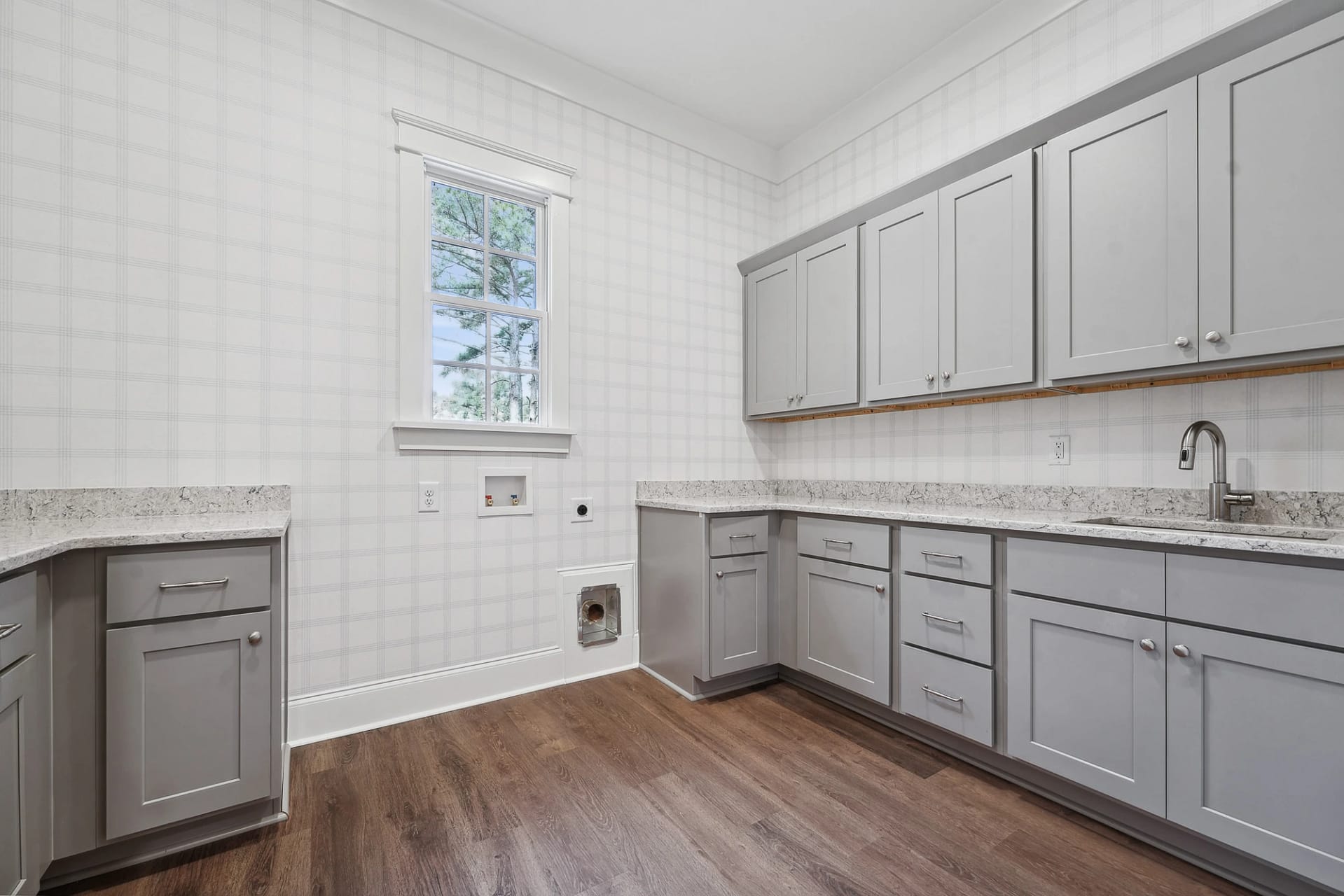 Laundry room with custom cabinetry in Holly Springs custom build