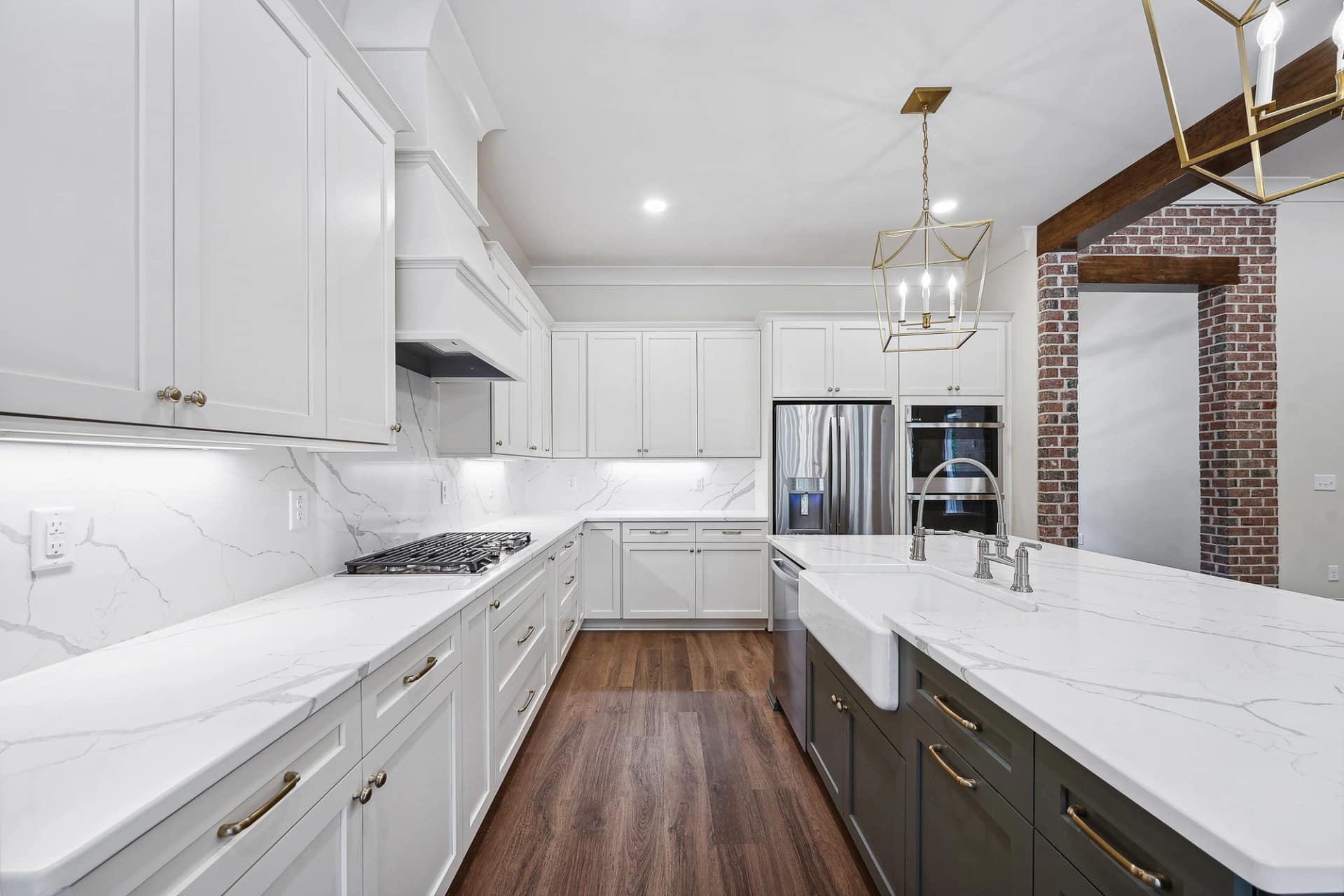 White custom kitchen with large island and quartz countertops in Holly Springs home