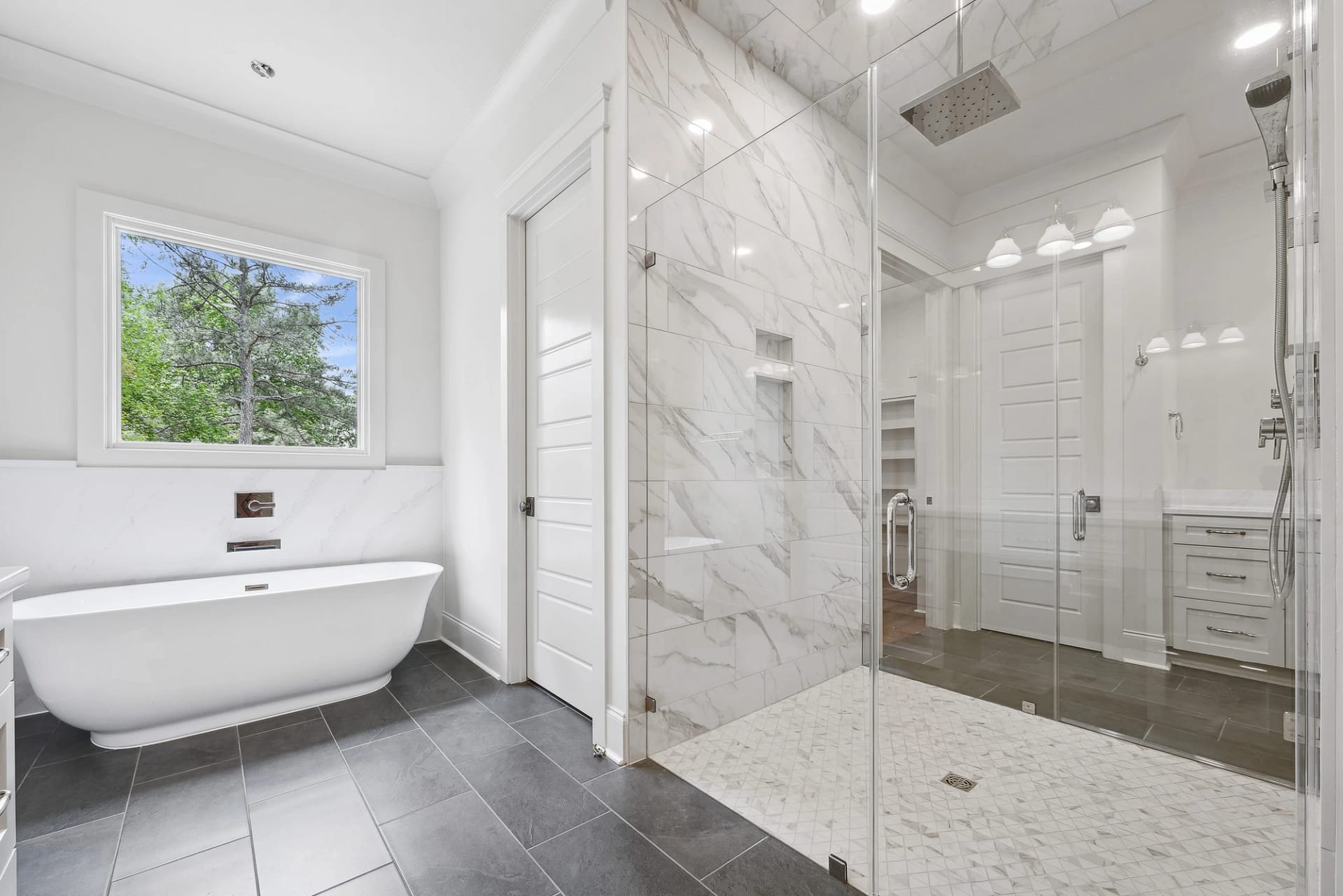 Walk-in shower and soaking tub in primary bathroom of Holly Springs home