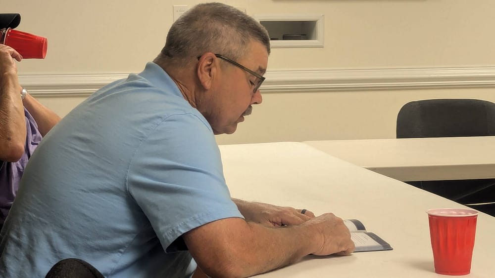 Men doing bible study seated in Fellowship Hall at Rawls Baptist Church