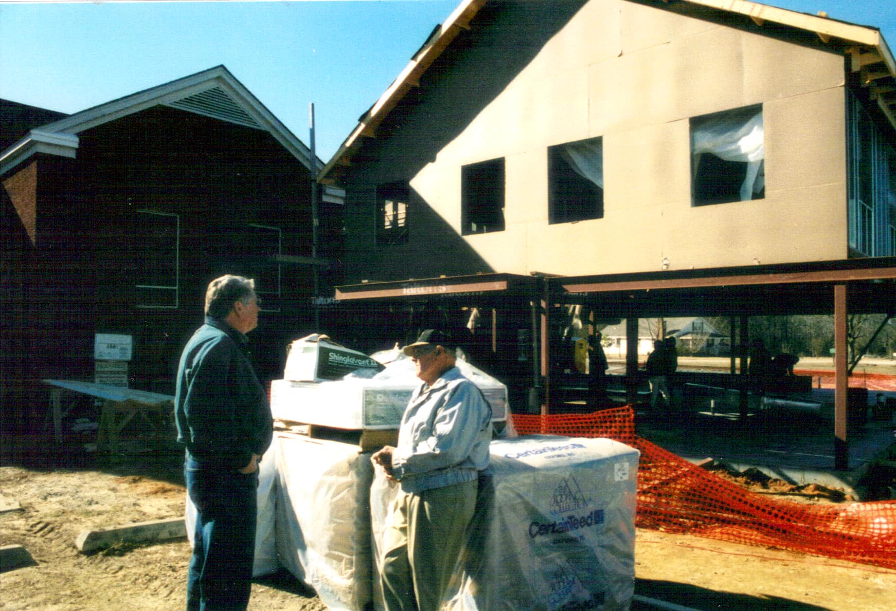 Supervising the Build, 2005 Wooden framing and exterior sheathing applied to the second story as the education and fellowship wing takes shape.