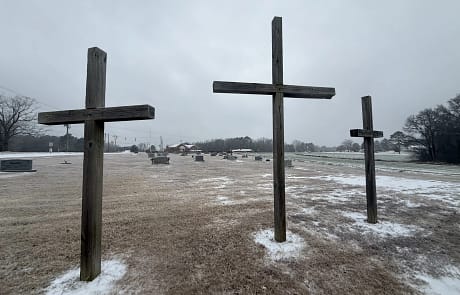 easter_crosses 3 large crosses on top of brown grass with snow on the basin in the Rawls Baptist church Cemetary