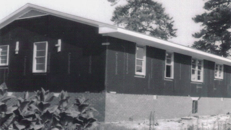 North Side Framing and Brickwork Construction of the Rawls Baptist Church parsonage in Fuquay-Varina, NC, during July 1960, showing progress and congregation involvement.
