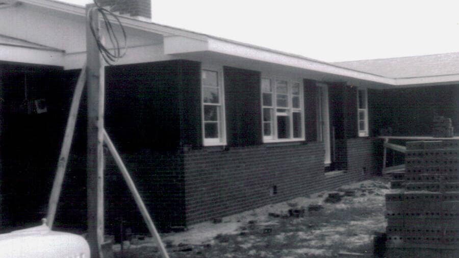 Final Brickwork and Exterior Finishing Construction of the Rawls Baptist Church parsonage in Fuquay-Varina, NC, during July 1960, showing progress and congregation involvement.