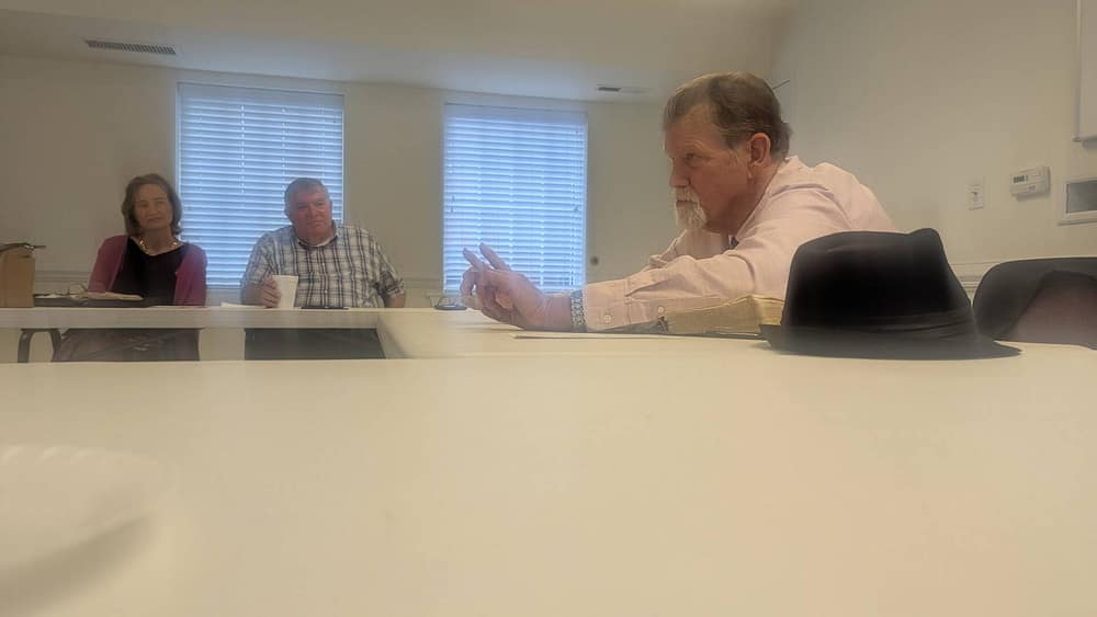 Church member at Rawls Baptist church seated at a table giving a bible study lesson for Sunday school