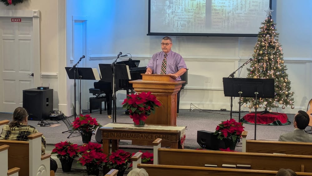 Donnie Simpson guest preaching at Rawls Baptist Church with Christmas decorated stage