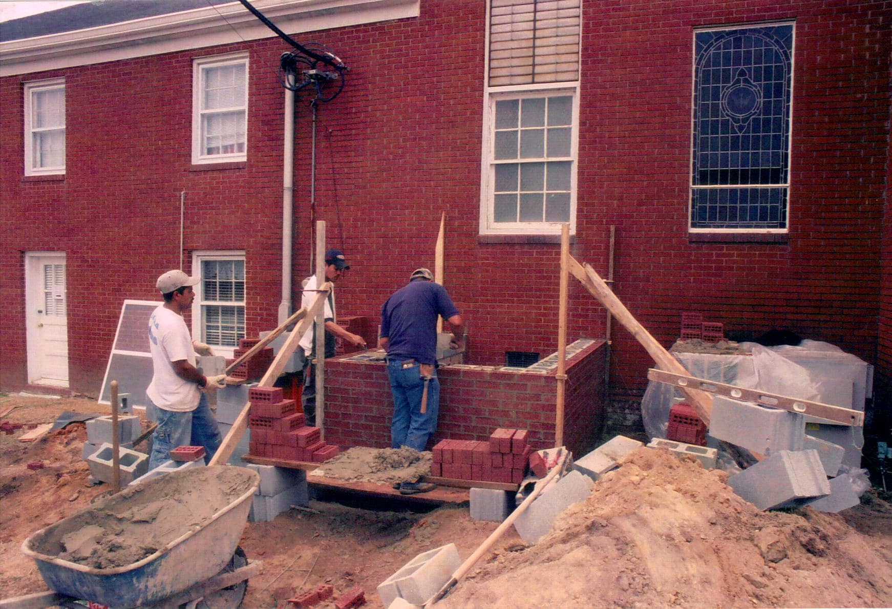 Laying the Foundation, 2005 Brick masons begin laying the foundation and walls for the new wing of Rawls Baptist Church during the 2005 expansion project.