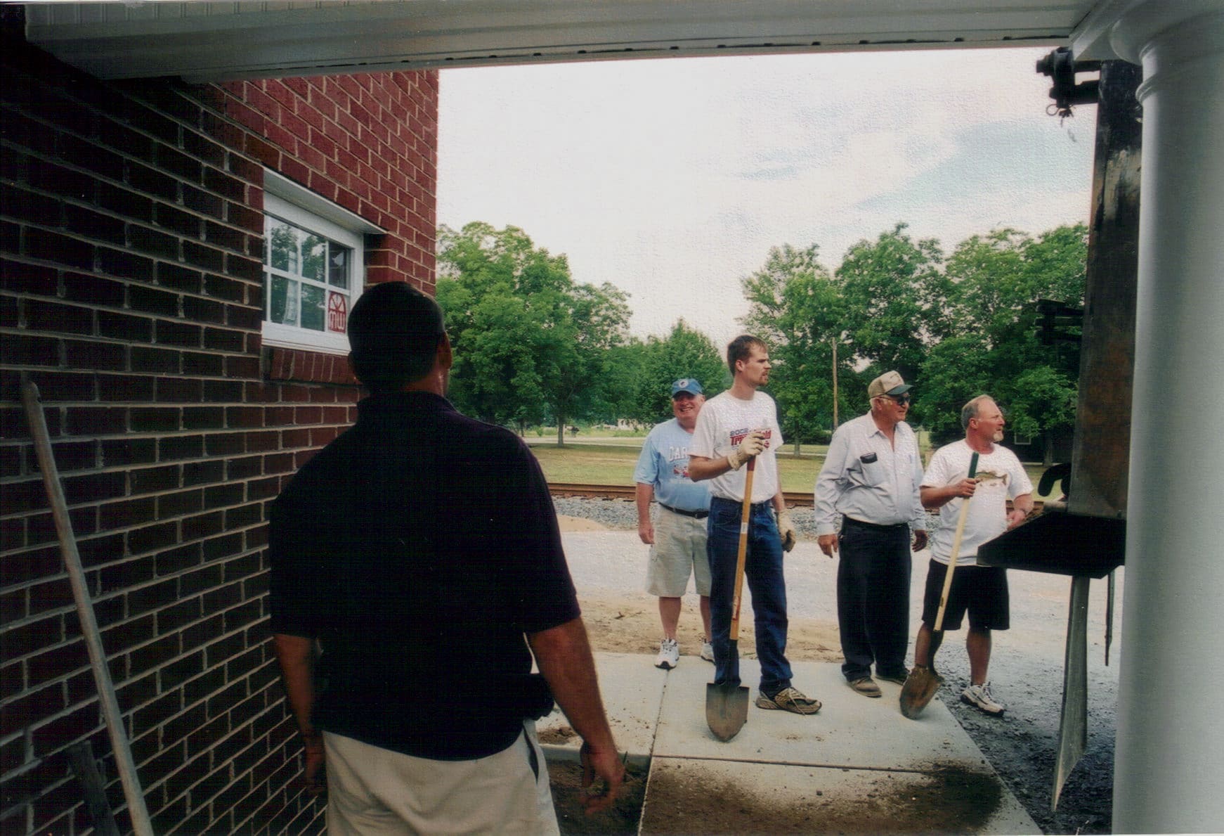 Volunteer Workday, 2005 Church members volunteering during final stages of construction at Rawls Baptist Church, working on landscaping and finishing touches near the new front entrance.