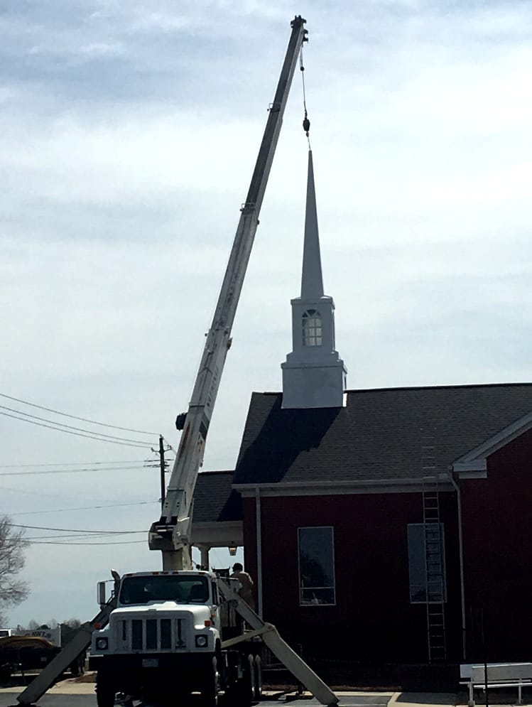 Steeple Lifted into Place by Crane (2018) Crane lifting newly constructed steeple into position atop Rawls Baptist Church sanctuary during 2018 installation.