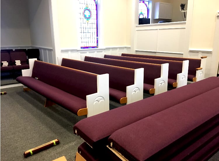 New Pews Completed – Sanctuary View (2018) Sanctuary view at Rawls Baptist Church after new pews were added in 2018, highlighting updated seating and restored trim detail under stained glass.
