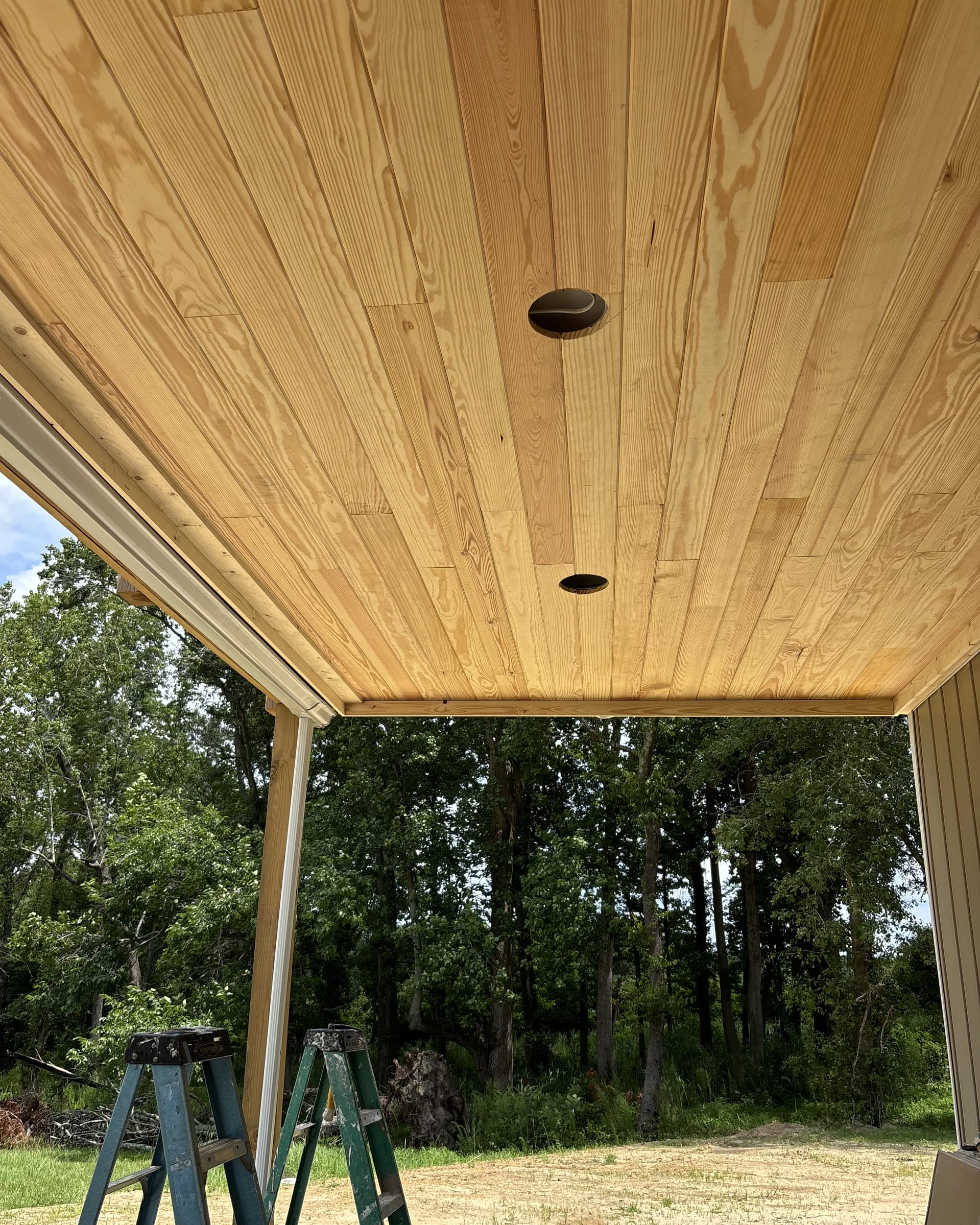 Tongue-and-groove ceiling installation showing multiple light openings.