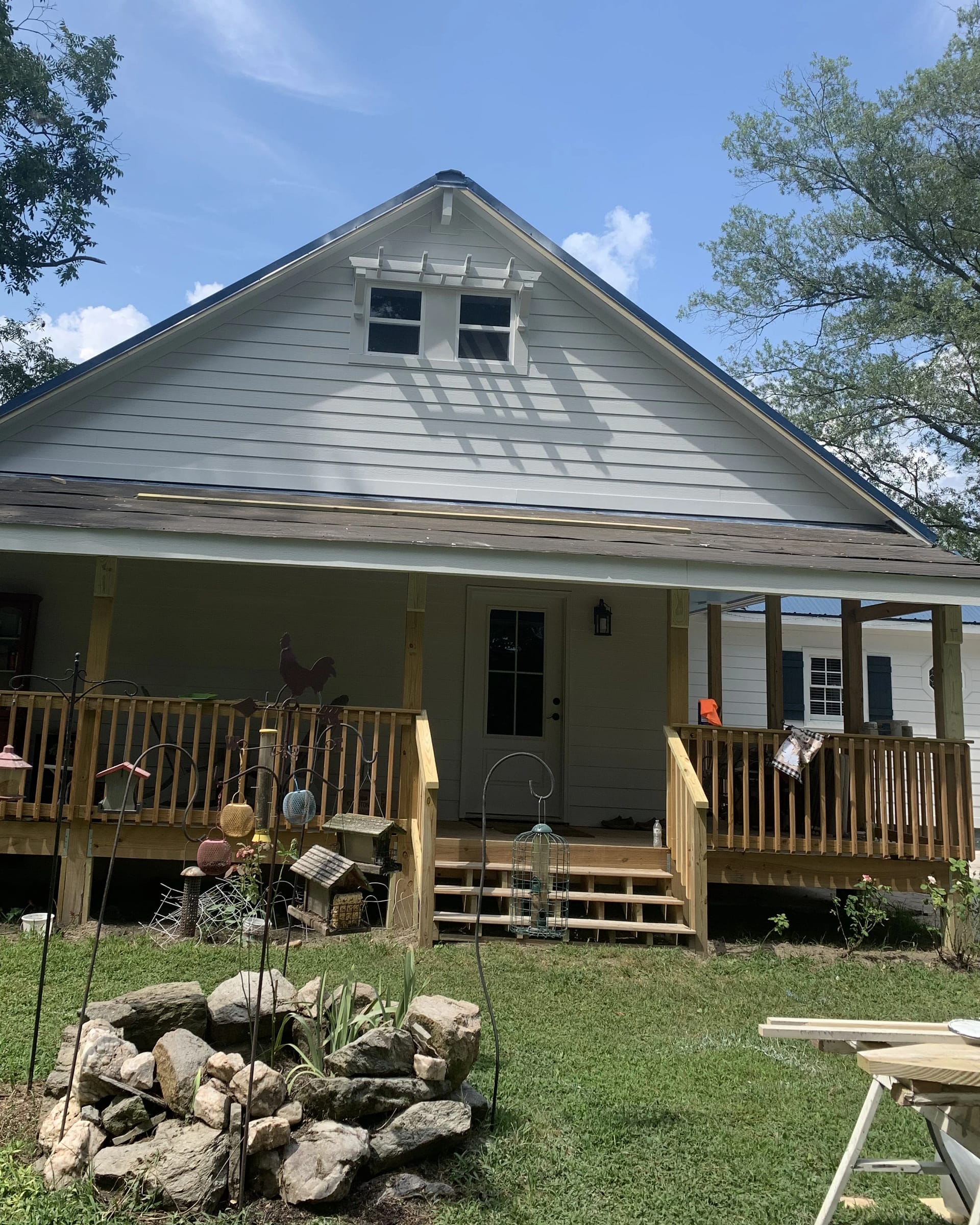 Front porch renovation with new railings, steps, and wood framing.