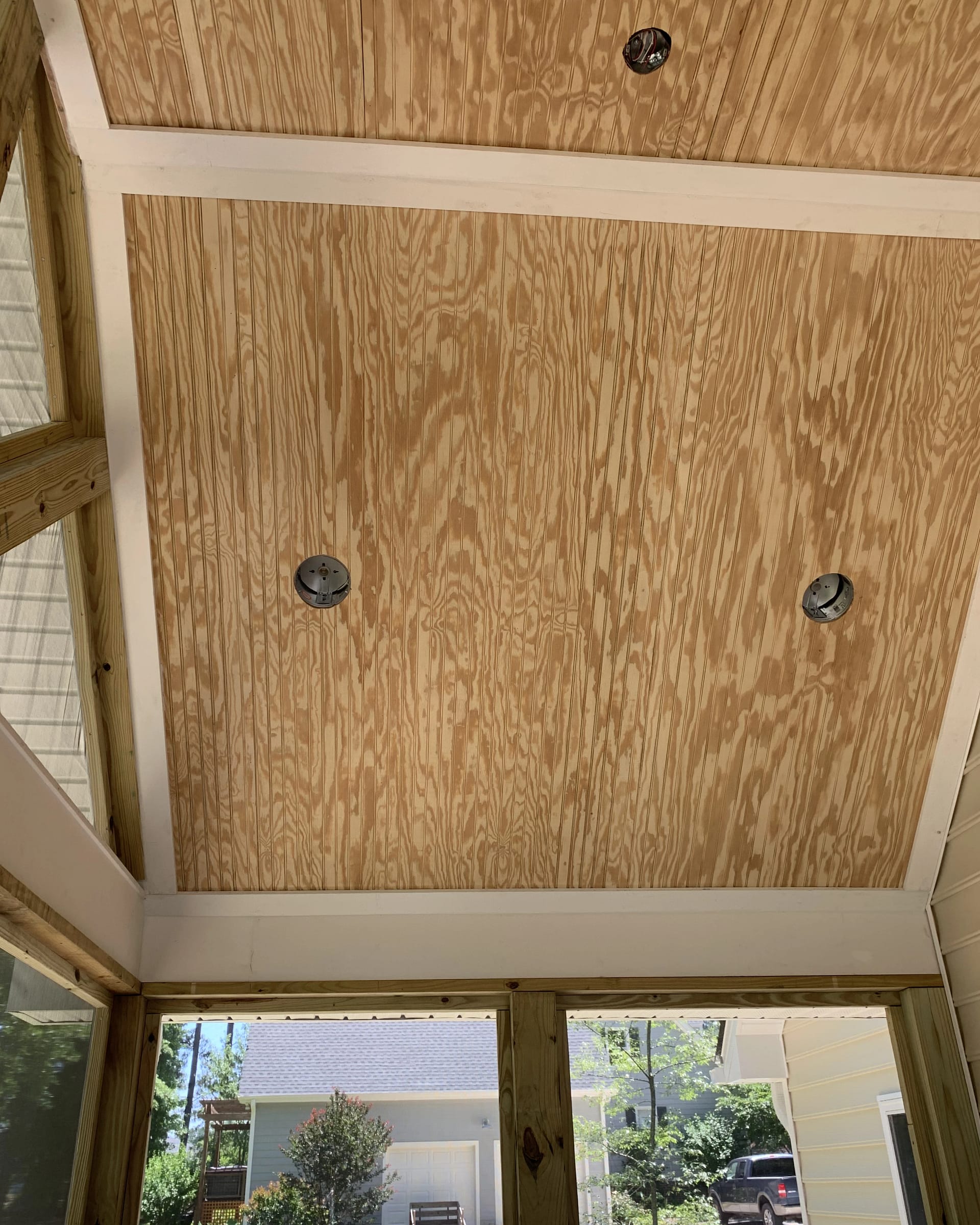 Ceiling framing in progress for a screened porch addition.