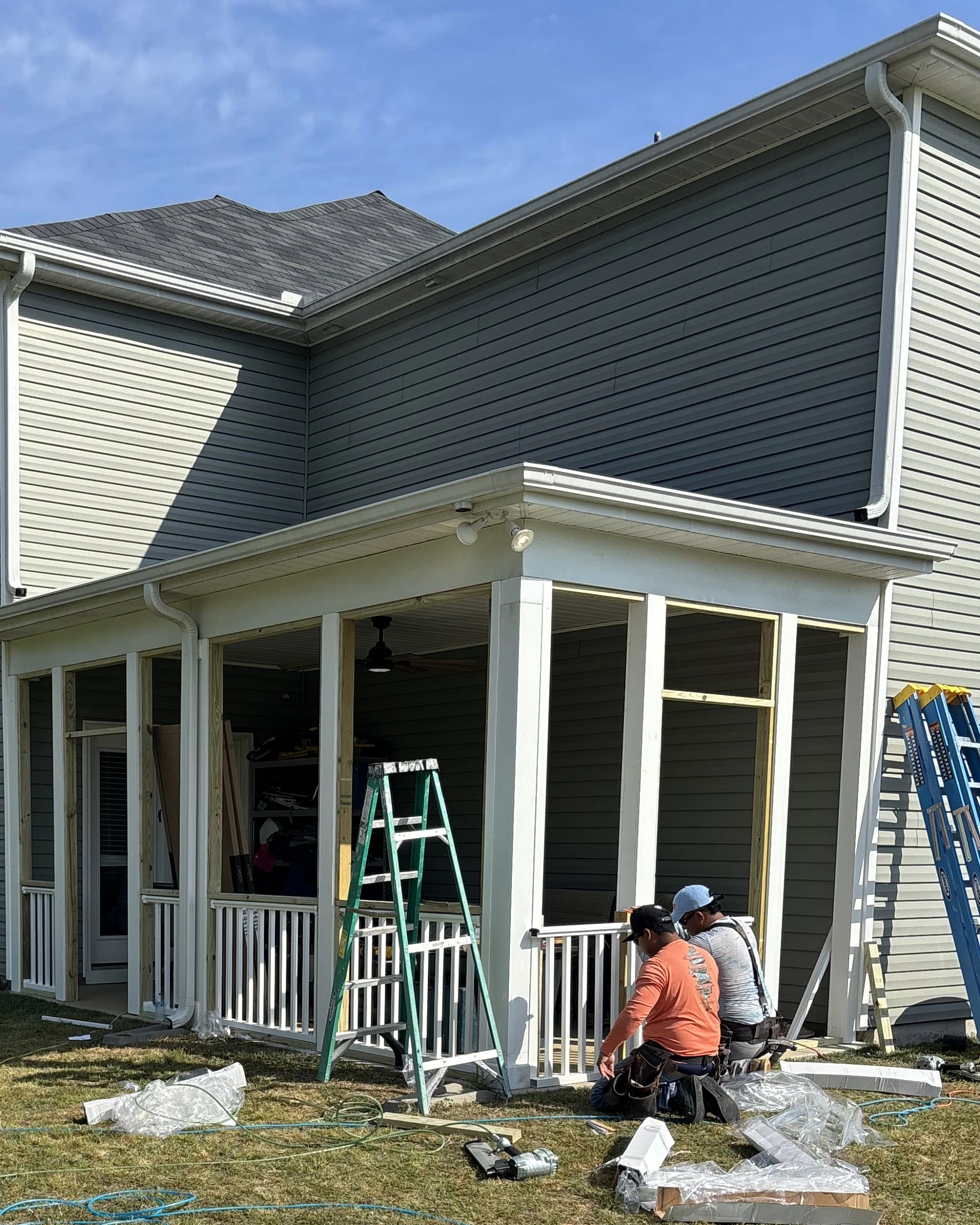 Full screened-porch framing with posts, beams, and railing sections.