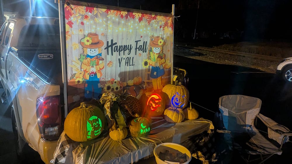 Rawls Baptist Church Trunk or Treat Happy Fall Y'all Banner with lit up Pumpkins