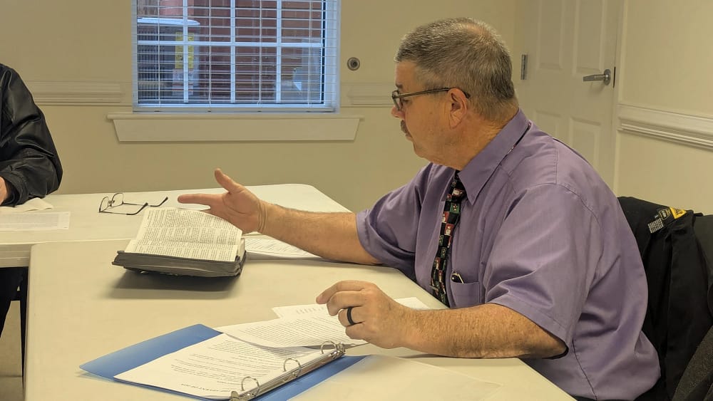 Church member giving a Sunday School Lesson to Men and Couples