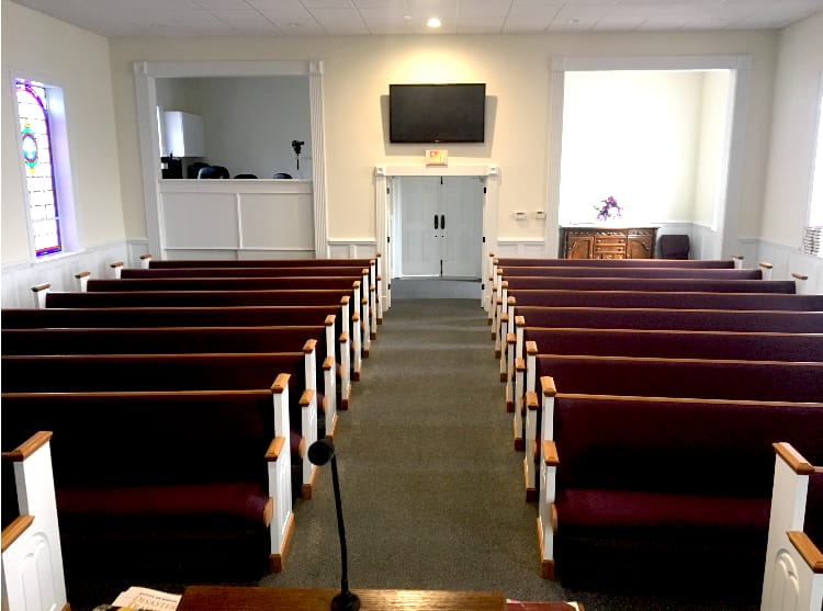 View from Pulpit – New Seating Completed (2018) Center aisle view from pulpit showing newly installed pews at Rawls Baptist Church in 2018, part of sanctuary upgrades for improved worship seating.