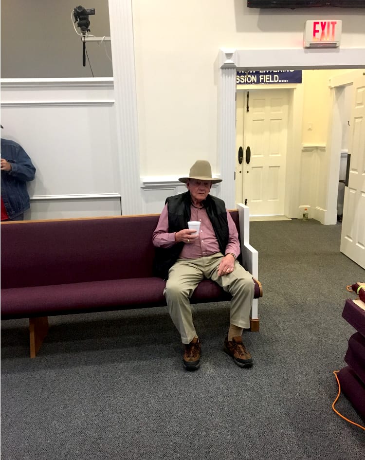 M.R. Smith testing out the new pews in the sanctuary